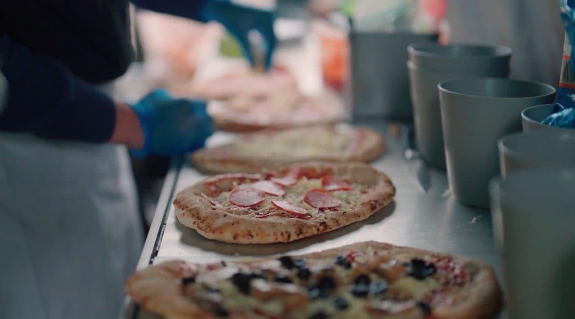 Freshly prepared pizzas being served at a wedding in the Cotswolds