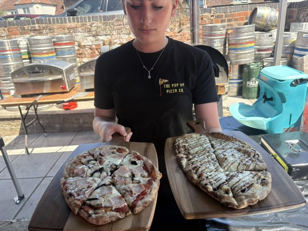Team member serving freshly made pizzas at a corporate event in Gloucester