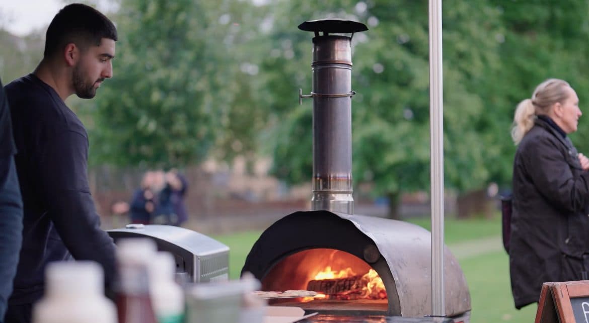 Chef crafting wood-fired pizzas at a wedding reception in the Cotswolds